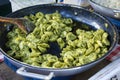 Italian pasta with pesto sauce in a big pan, selling in the street. Italian street food Royalty Free Stock Photo