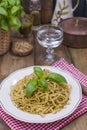 Italian pasta with pesto sauce and fresh basil. A delicious homemade dinner. Photo in a rustic style. Copy space Royalty Free Stock Photo