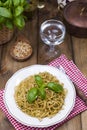 Italian pasta with pesto sauce and fresh basil. A delicious homemade dinner. Photo in a rustic style. Copy space Royalty Free Stock Photo