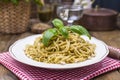 Italian pasta with pesto sauce and fresh basil. A delicious homemade dinner. Photo in a rustic style. Copy space Royalty Free Stock Photo