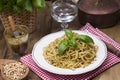 Italian pasta with pesto sauce and fresh basil. A delicious homemade dinner. Photo in a rustic style. Copy space Royalty Free Stock Photo