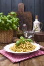 Italian pasta with pesto sauce and fresh basil. A delicious homemade dinner. Photo in a rustic style. Copy space Royalty Free Stock Photo