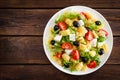 Italian pasta salad with fresh tomato, cheese, lettuce and olives on wooden background. Mediterranean cuisine. Cooking lunch. Hea Royalty Free Stock Photo