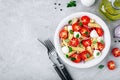 Italian pasta salad with tomatoes, mozzarella cheese, red onion and basil. Top view Royalty Free Stock Photo