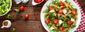 Italian pasta salad with wholegrain fusilli, fresh tomato, cheese, lettuce and broccoli on wooden rustic background. Banner Royalty Free Stock Photo