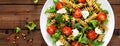 Italian pasta salad with wholegrain fusilli, fresh tomato, cheese, lettuce and broccoli on wooden rustic background Royalty Free Stock Photo