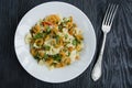 Italian pasta in a sauce with shrimps on a plate, top view. Dark wooden background Royalty Free Stock Photo