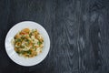 Italian pasta in a sauce with shrimps on a plate, top view. Dark wooden background. Space for text Royalty Free Stock Photo