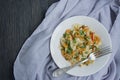 Italian pasta in a sauce with shrimps on a plate, top view. Dark wooden background. Space for text Royalty Free Stock Photo