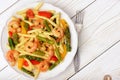 Italian pasta with shrimps, asparagus, paprika and tomatoes. Royalty Free Stock Photo