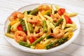 Italian pasta with shrimps, asparagus, paprika and tomatoes. Royalty Free Stock Photo