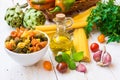 Italian pasta spaghetti fusilli, bottle of olive oil, basil, cherry tomatoes, garlic, herbs and vegetables, dinner ingredients Royalty Free Stock Photo