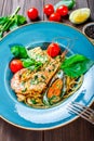 Italian pasta spaghetti with seafood, langoustine, mussels, squid, scallops, shrimp, Parmesan cheese Royalty Free Stock Photo