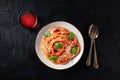 Italian pasta. Spaghetti with tomato sauce, grated Parmesan cheese and fresh basil, overhead shot on a dark background Royalty Free Stock Photo