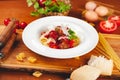 Italian pasta. Spaghetti with tomato sauce and meatballs on white plate with parmesan cheese, fresh parsley and tomatoes Royalty Free Stock Photo