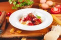 Italian pasta. Spaghetti with tomato sauce and meatballs on white plate with parmesan cheese, fresh parsley and tomatoes on rustic Royalty Free Stock Photo