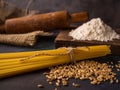 Italian pasta, spaghetti, wheat, rolling pin, flour on a textured background. Still life in a rustic style. Element for design Royalty Free Stock Photo