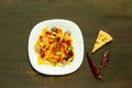 Italian pasta with tomato sauce and meatballs in a white plate on a wooden background. Concept of popular american spaghetti. Royalty Free Stock Photo