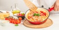 Italian pasta with tomatoes and basil in pan. Chef cooking spaghetti Royalty Free Stock Photo