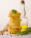 Italian pasta in a vertical serving, garlic, olive oil and a sprig of rosemary on a white background. Close-up. Cooking, Italian Royalty Free Stock Photo