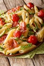 Italian penne pasta with fried prosciutto, tomato, zucchini and Royalty Free Stock Photo