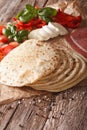 Italian piadina with the ingredients for the stuffing close-up. Royalty Free Stock Photo
