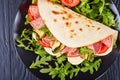 Italian piadina with mozzarella, tomato, salami Royalty Free Stock Photo