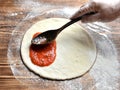 Italian pizza cooking preparation process on rustic wood table Royalty Free Stock Photo