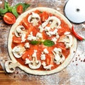 Italian pizza cooking preparation process on rustic wood table Royalty Free Stock Photo
