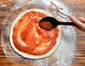 Italian pizza cooking preparation process on rustic wood table. Royalty Free Stock Photo