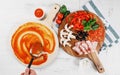 Italian pizza cooking process on white table. Backstage of preparation. Process step by step. Pizza dough and ingredients. Royalty Free Stock Photo