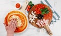 Italian pizza cooking process on white table. Backstage of preparation. Process step by step. Pizza dough and ingredients. Royalty Free Stock Photo