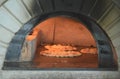 Italian pizza cooking in a tradition oven Royalty Free Stock Photo