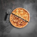 Italian pizza cut in half with cutter on the grey background. Top view and square flat lay photo Royalty Free Stock Photo