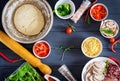 Italian pizza. Dough and pizza ingredients. Dough, cheese, tomatoes Royalty Free Stock Photo
