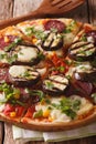 Italian pizza with eggplant, sausage, corn and cheese macro on a