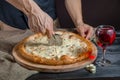 Italian pizza 4 four cheese on the Board with pizza cutter and wine Royalty Free Stock Photo