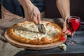 Italian pizza 4 four cheese on the Board with pizza cutter and wine Royalty Free Stock Photo