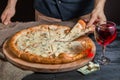 Italian pizza 4 four cheese on the Board with pizza cutter and wine Royalty Free Stock Photo