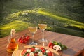 Italian pizza with glasses of white wine against Tuscan vineyards near the Florence in Italy Royalty Free Stock Photo