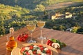 Italian pizza with glasses of white wine against Tuscan vineyards near the Florence in Italy Royalty Free Stock Photo