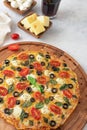 Italian pizza with ingredients. Mazzarella cheese, tomatoes and basil leaves. On a wooden board, white background. View from above