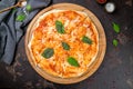 Italian pizza Margherita with basil on wooden board on dark concrete table top view Royalty Free Stock Photo