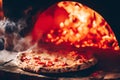 Pizza Margherita coming out of the wood fire oven Royalty Free Stock Photo