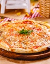 Italian Pizza Margherita with tomatoes and mozzarella cheese on wooden cutting board Royalty Free Stock Photo