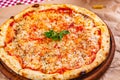 Italian Pizza Margherita with tomatoes and mozzarella cheese on wooden cutting board Royalty Free Stock Photo