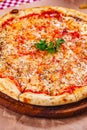 Italian Pizza Margherita with tomatoes and mozzarella cheese on wooden cutting board. Royalty Free Stock Photo