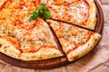 Italian Pizza Margherita with tomatoes and mozzarella cheese on wooden cutting board. Royalty Free Stock Photo