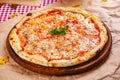 Italian Pizza Margherita with tomatoes and mozzarella cheese on wooden cutting board. Royalty Free Stock Photo