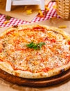 Italian Pizza Margherita with tomatoes and mozzarella cheese on wooden cutting board. Royalty Free Stock Photo